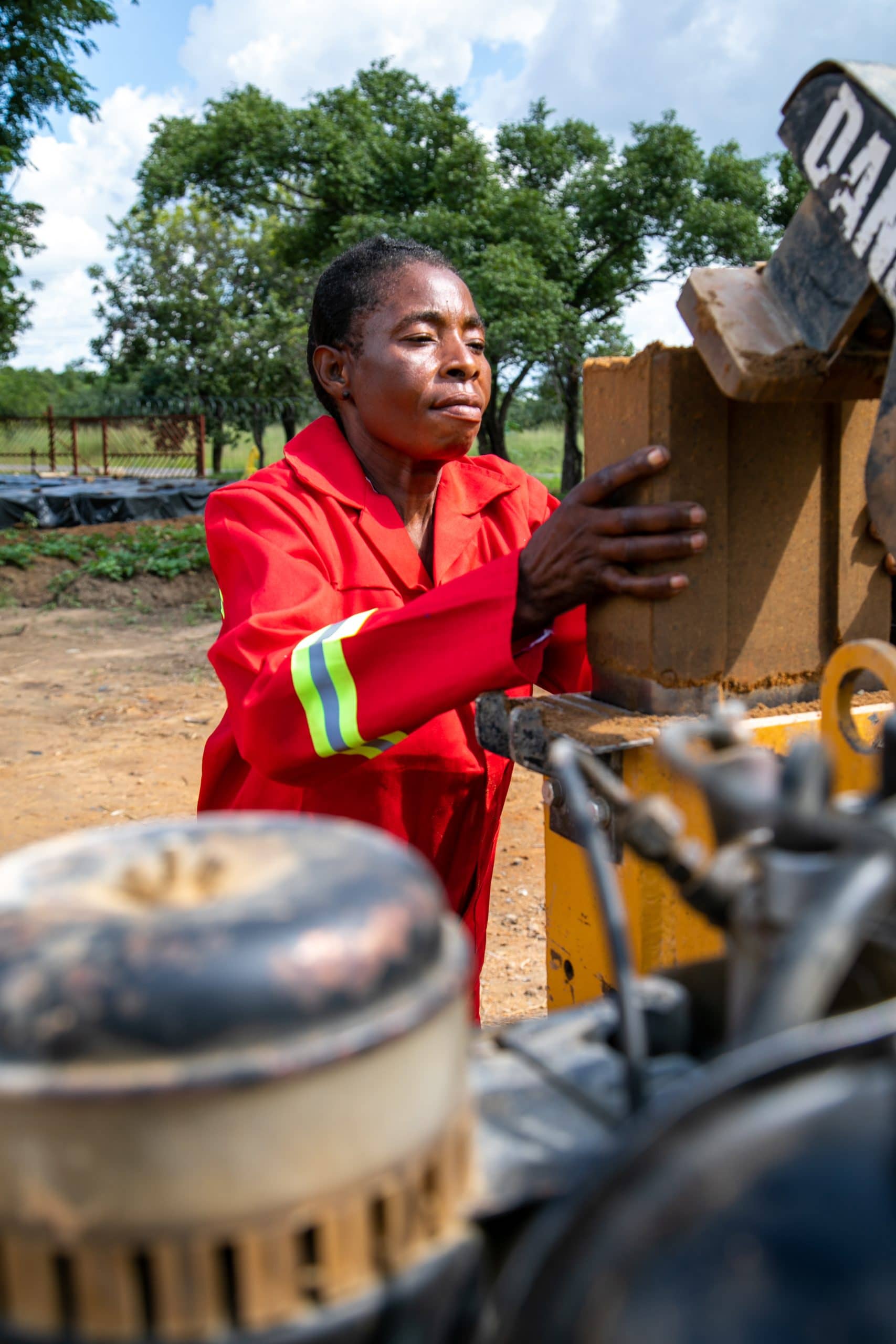 Zambian woman working construction and making bricks for the Carol Zulu Primary School.