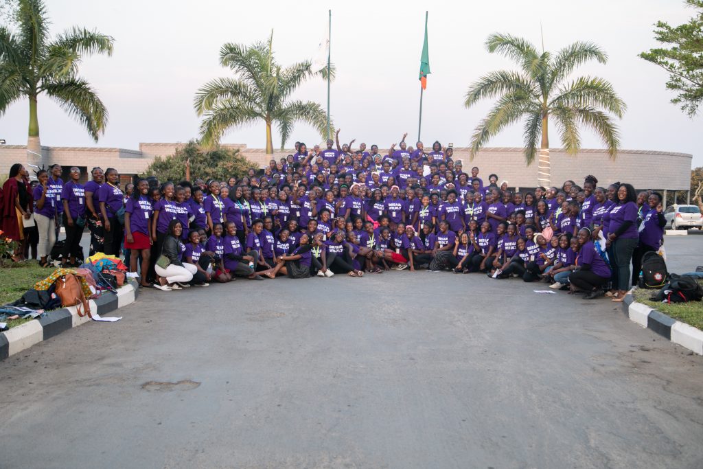 300 plus attendees at the 2022 Be That Girl Conference smiling for a picture and wearing their purple "dream wildly" shirts.