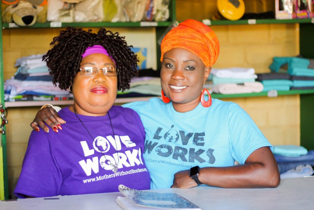 Josephine Daka, our Zambian country director, with her arm around another Mothers Without Borders employee, both of them wearing love works t-shirts.