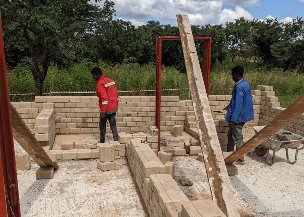 Zambian construction workers buildings walls at the new CRC.