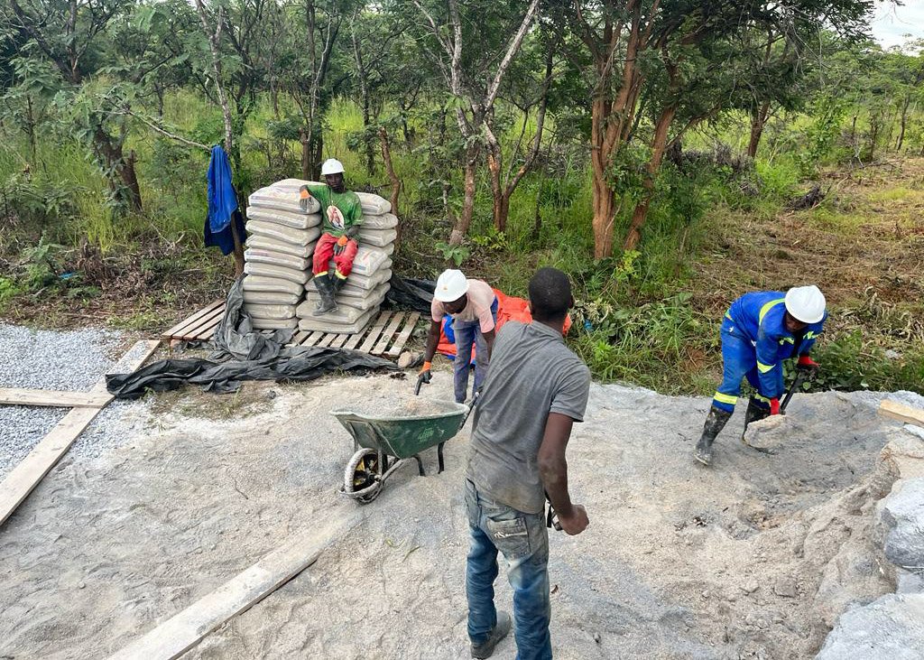 Men in Zambia mixing cement while building the new Children's Resource Center.